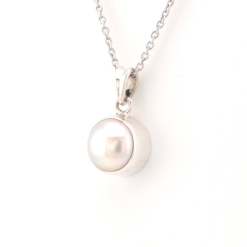 Pearl necklace with a silver clasp on a white background
