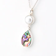 Necklace with a pearl and abalone shell pendant on a white background