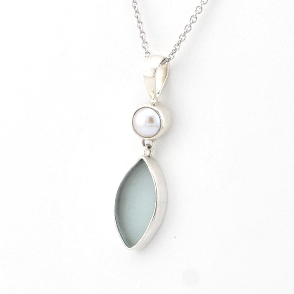 Necklace with a pendant featuring a teardrop-shaped light blue stone and a pearl on a white background