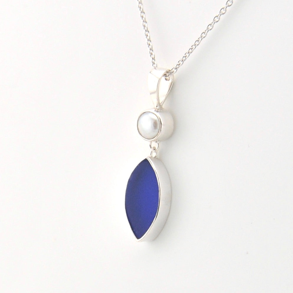 Necklace with a blue pendant and pearl on a white background