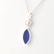 Necklace with a blue pendant and pearl on a white background