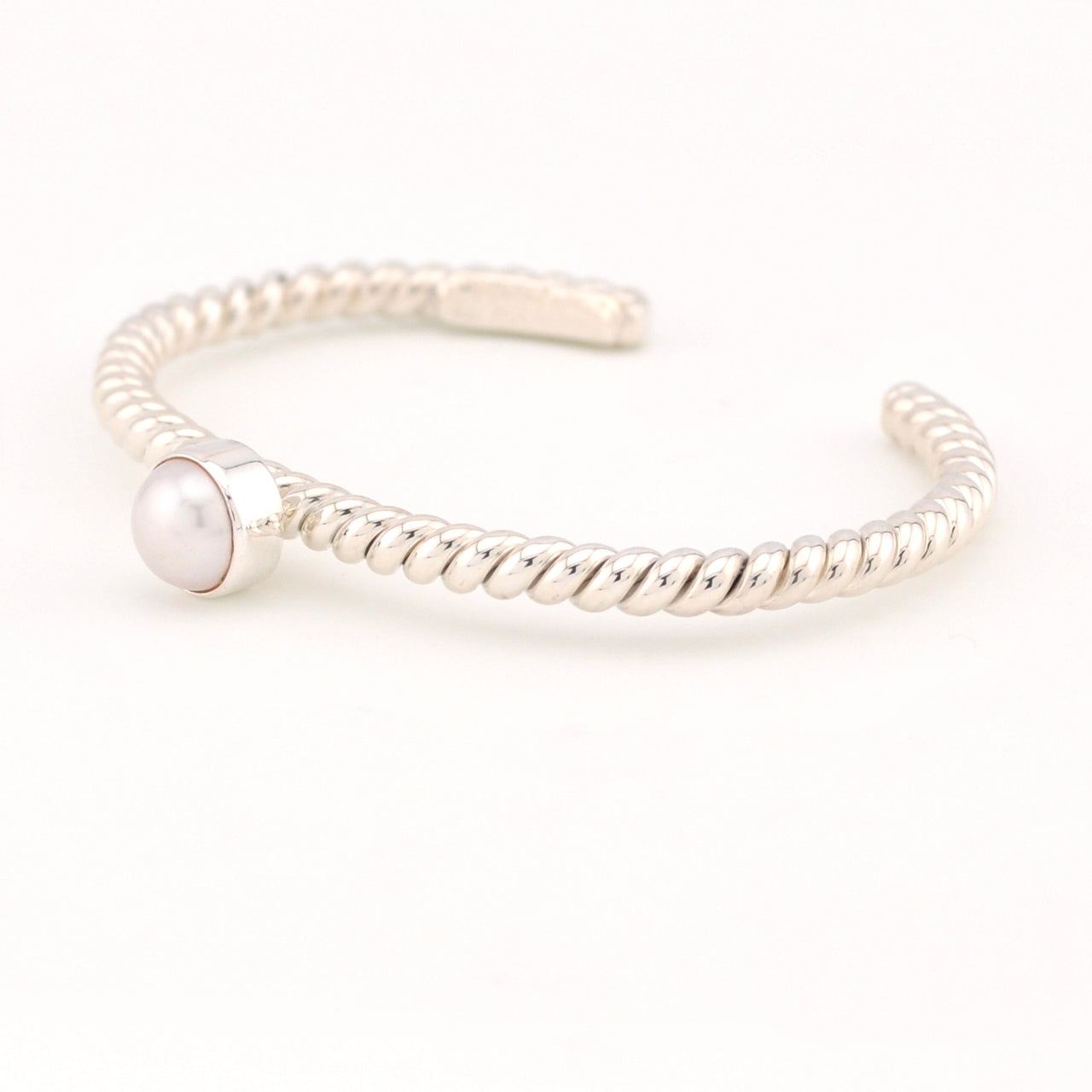 Silver bracelet with a pearl on a white background