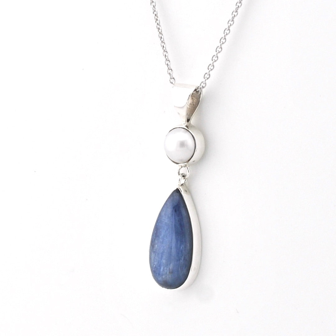 Necklace with a blue teardrop pendant and pearl on a white background