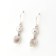 Pair of earrings with pearls and shell elements on a white background