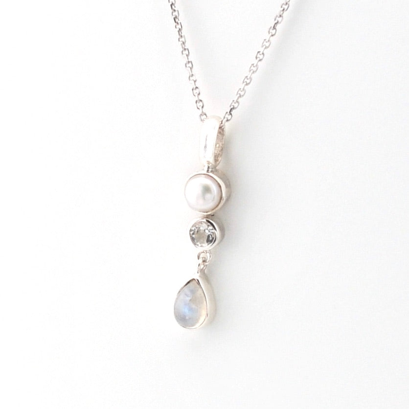 Necklace with pearl and teardrop-shaped pendant on a white background