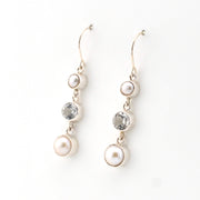 Pair of pearl and topaz drop earrings on a white background