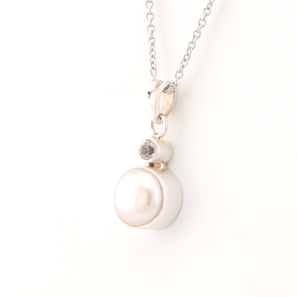 Pearl necklace with a silver chain on a white background