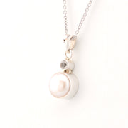 Pearl necklace with a silver chain on a white background