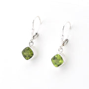 Pair of green gemstone earrings on a white background
