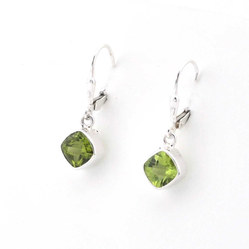 Pair of green gemstone earrings on a white background