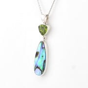 Jewelry with a green gemstone and multicolored pendant on a white background