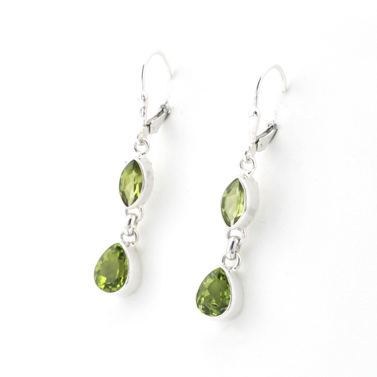 Pair of silver earrings with green gemstones on a white background