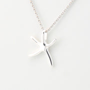 Silver starfish pendant necklace on a white background