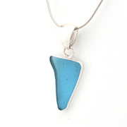 Blue pendant necklace on a white background