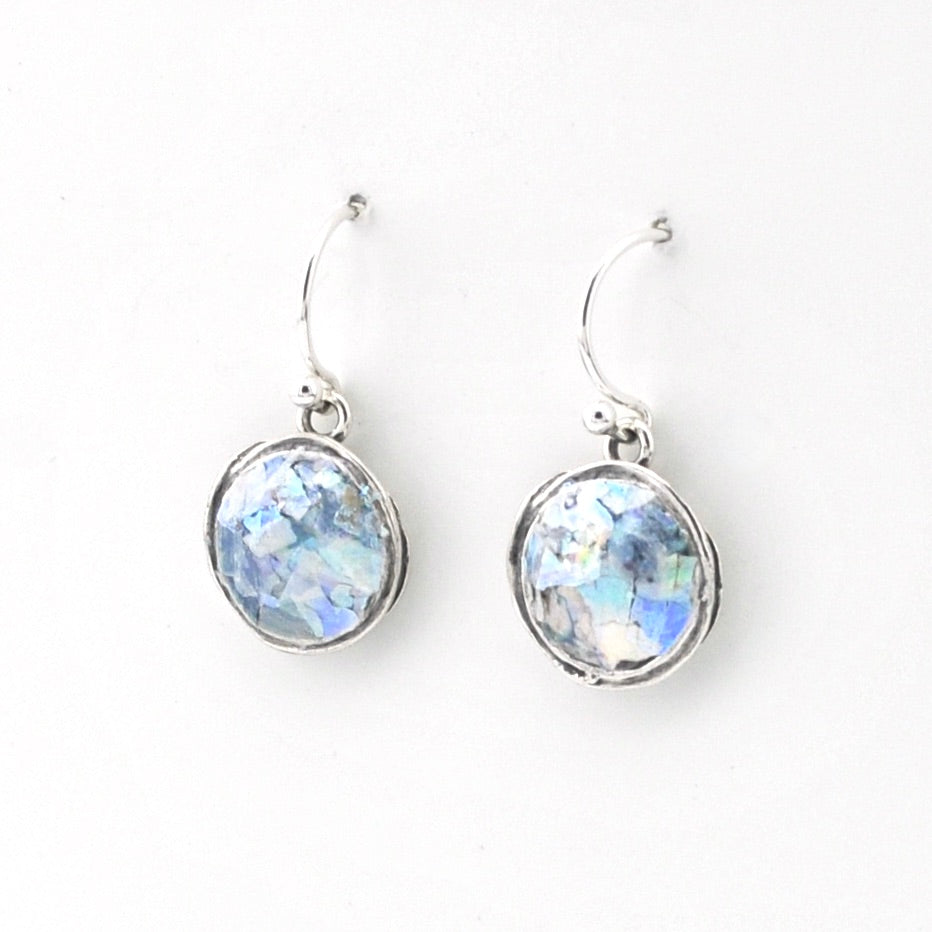 Pair of silver earrings with round, faceted gemstones on a white background