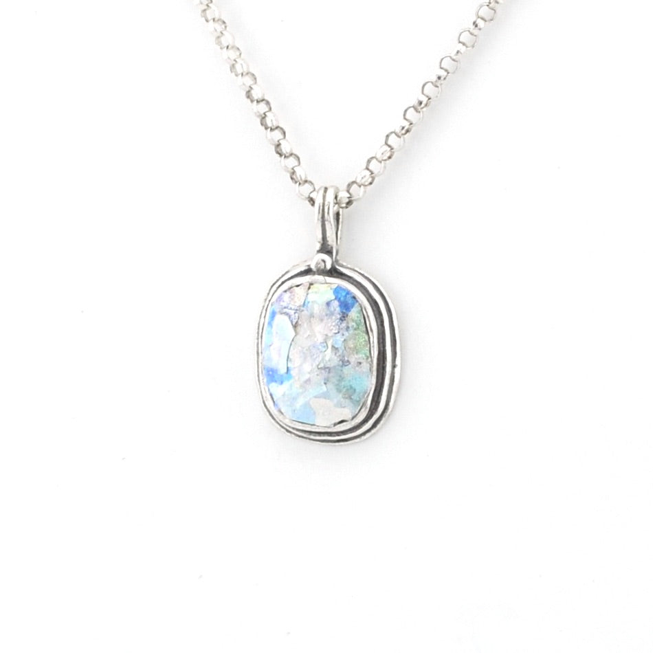 Silver necklace with a pendant featuring a colorful Roman glass on a white background