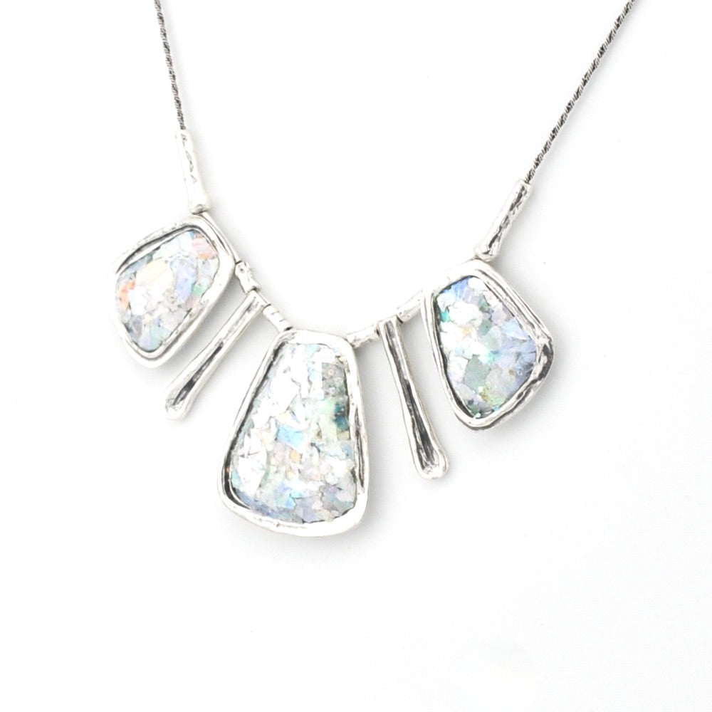Silver necklace with three rectangular Roman glass pieces on a white background