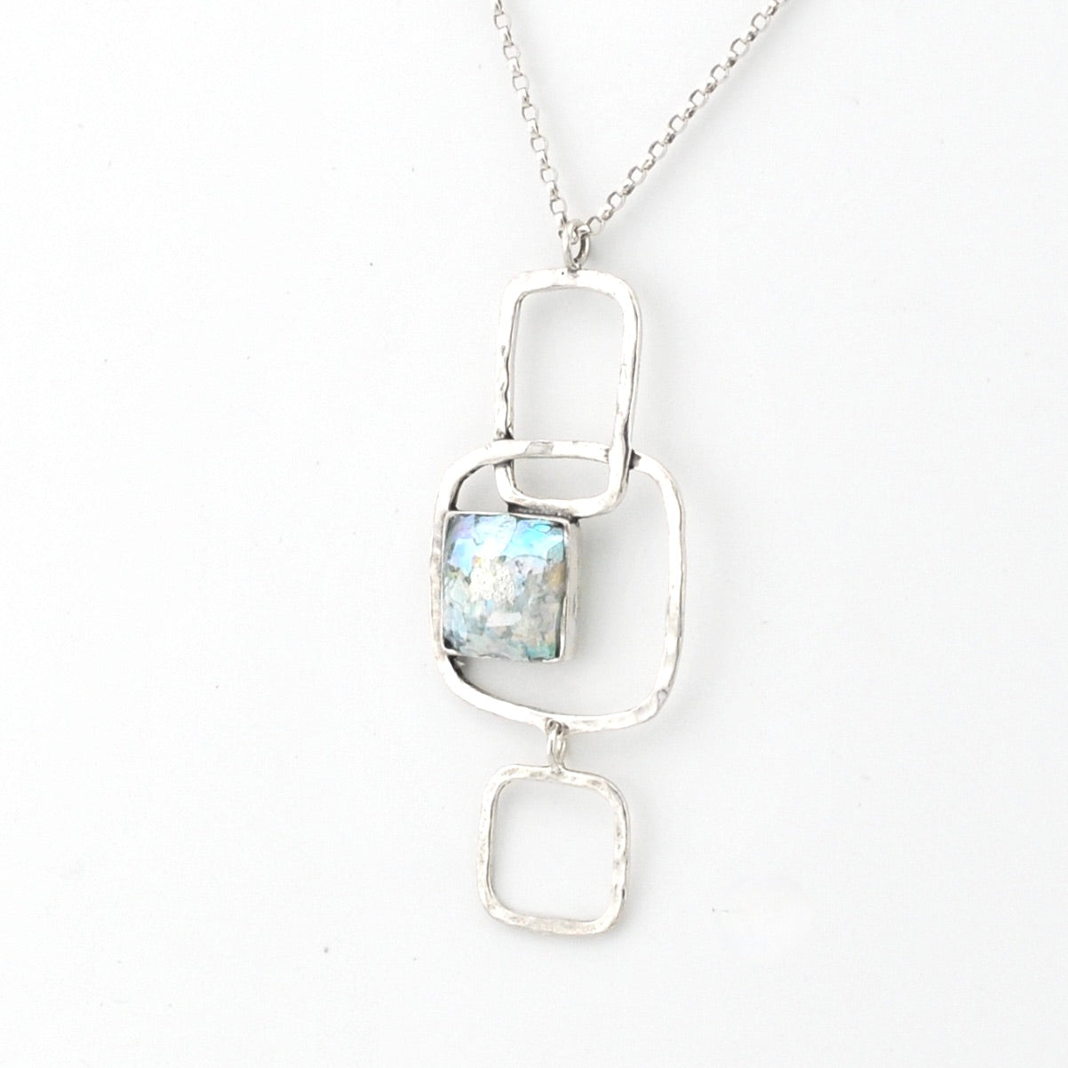 Silver pendant necklace with a Roman glass on a white background