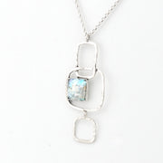 Silver pendant necklace with a Roman glass on a white background