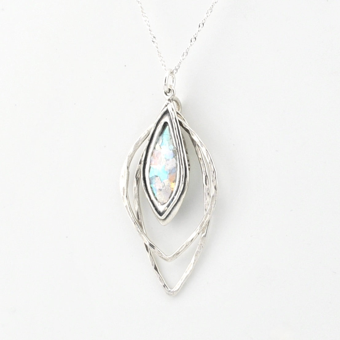 Silver pendant necklace with Roman glass on a white background