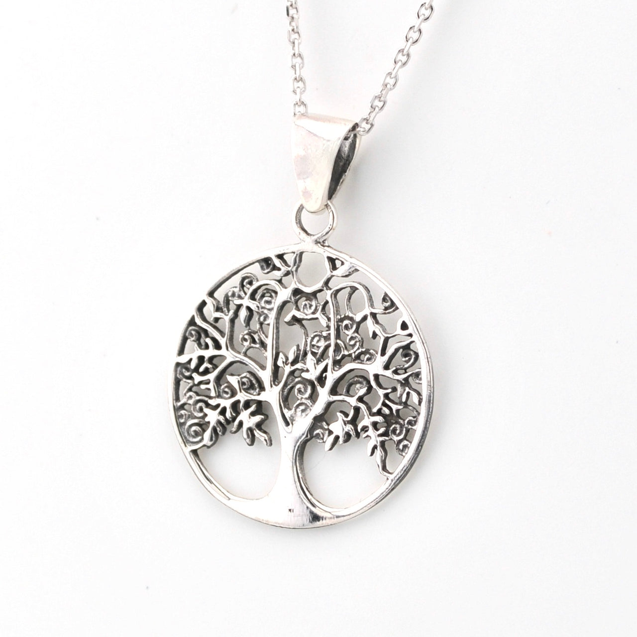 Silver tree of life pendant on a white background
