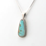 Turquoise pendant necklace on a white background