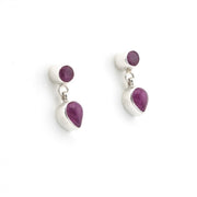 Pair of silver earrings with purple gemstones on a white background