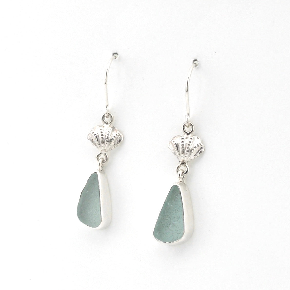 Pair of silver earrings with teardrop-shaped gray stones on a white background