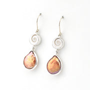 Pair of earrings with teardrop-shaped pink stones on a white background