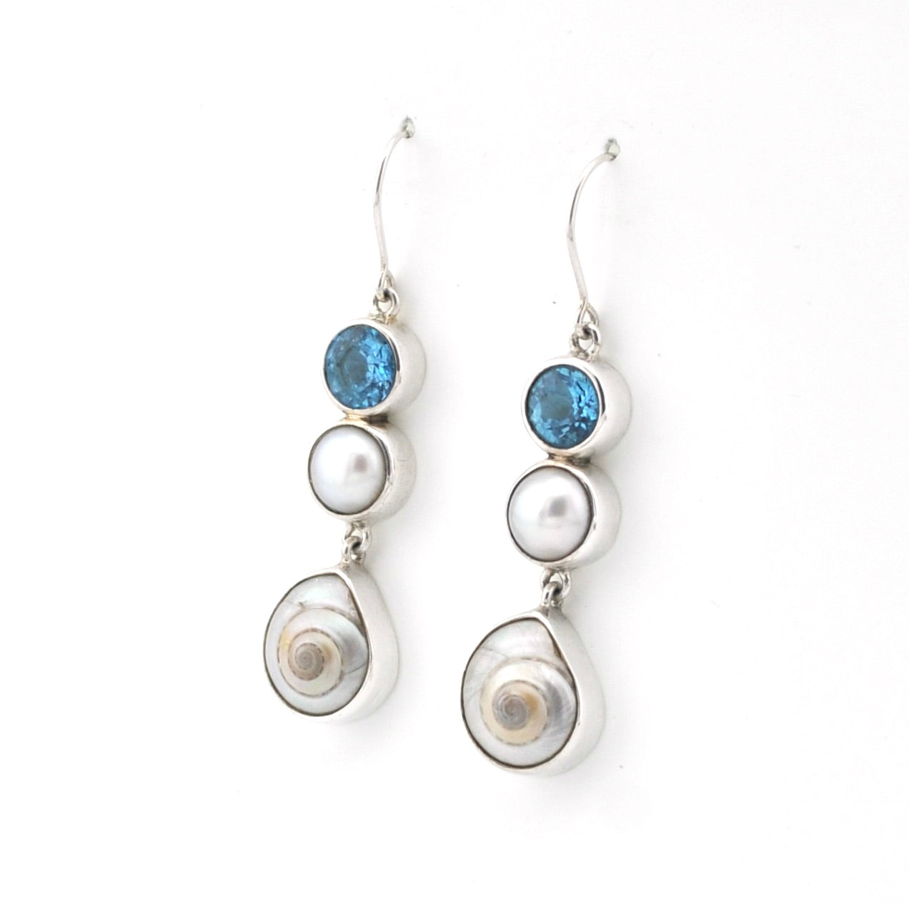 Pair of earrings with pearls and blue gemstones on a white background
