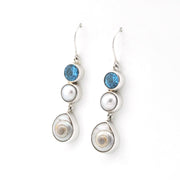 Pair of earrings with pearls and blue gemstones on a white background