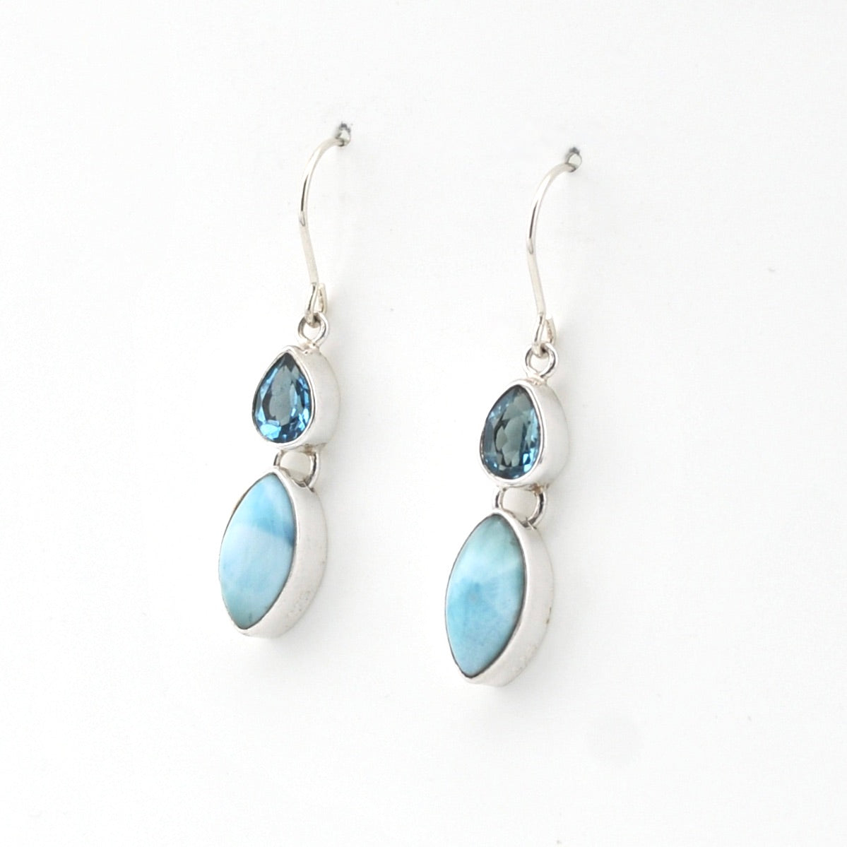 Pair of earrings with blue and white stones on a white background