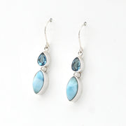 Pair of earrings with blue and white stones on a white background