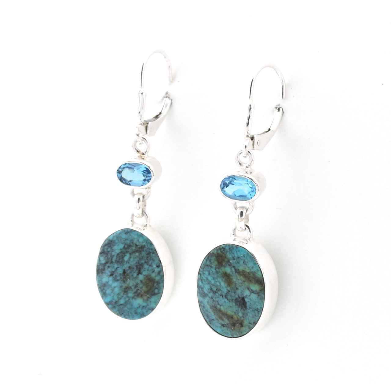 Pair of earrings with blue stones and oval-shaped stones on a white background