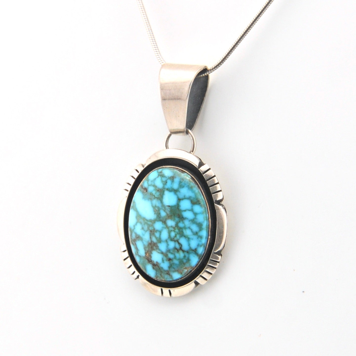 Turquoise pendant necklace on a white background
