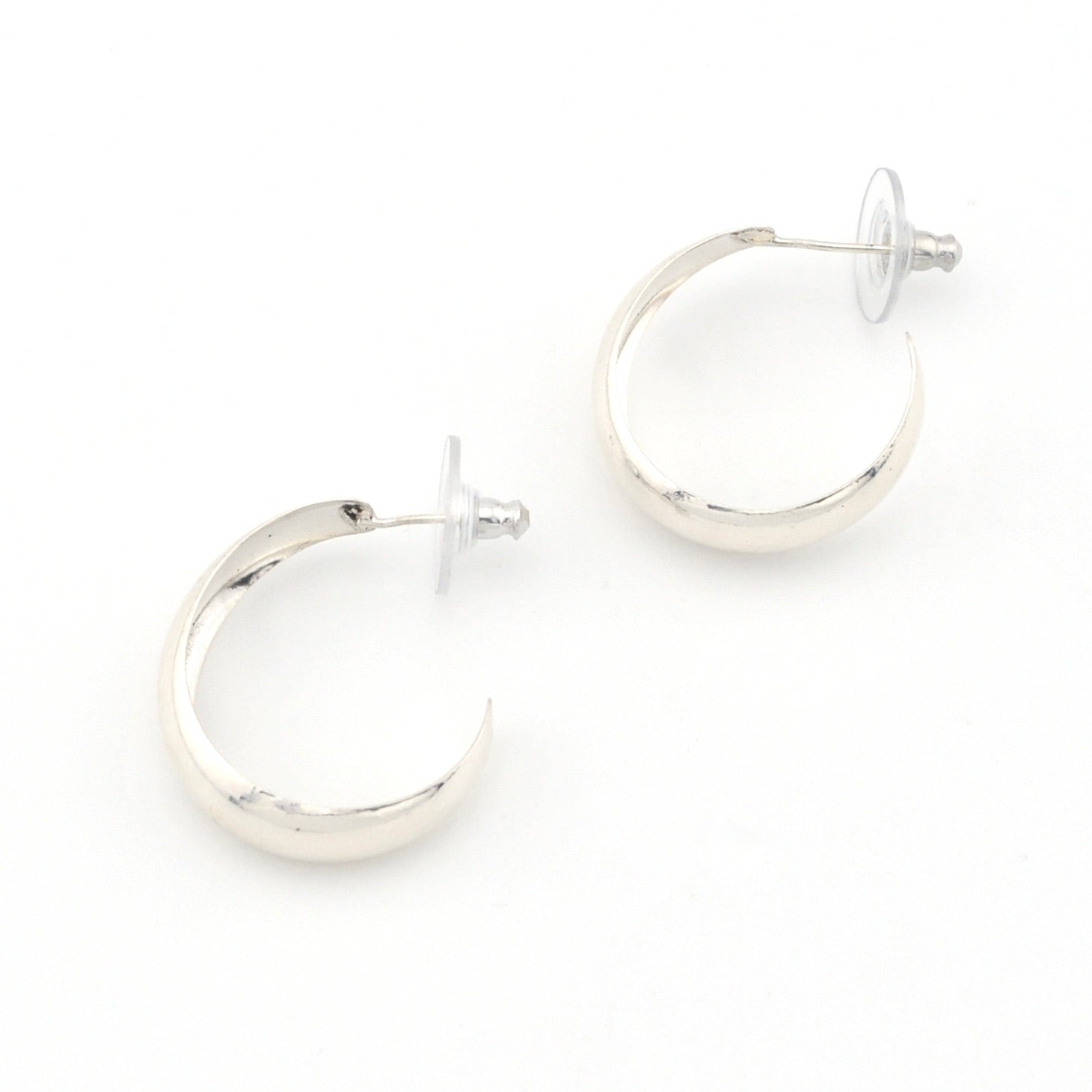 Silver hoop earrings on a white background