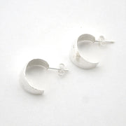 Silver hoop earrings on a white background