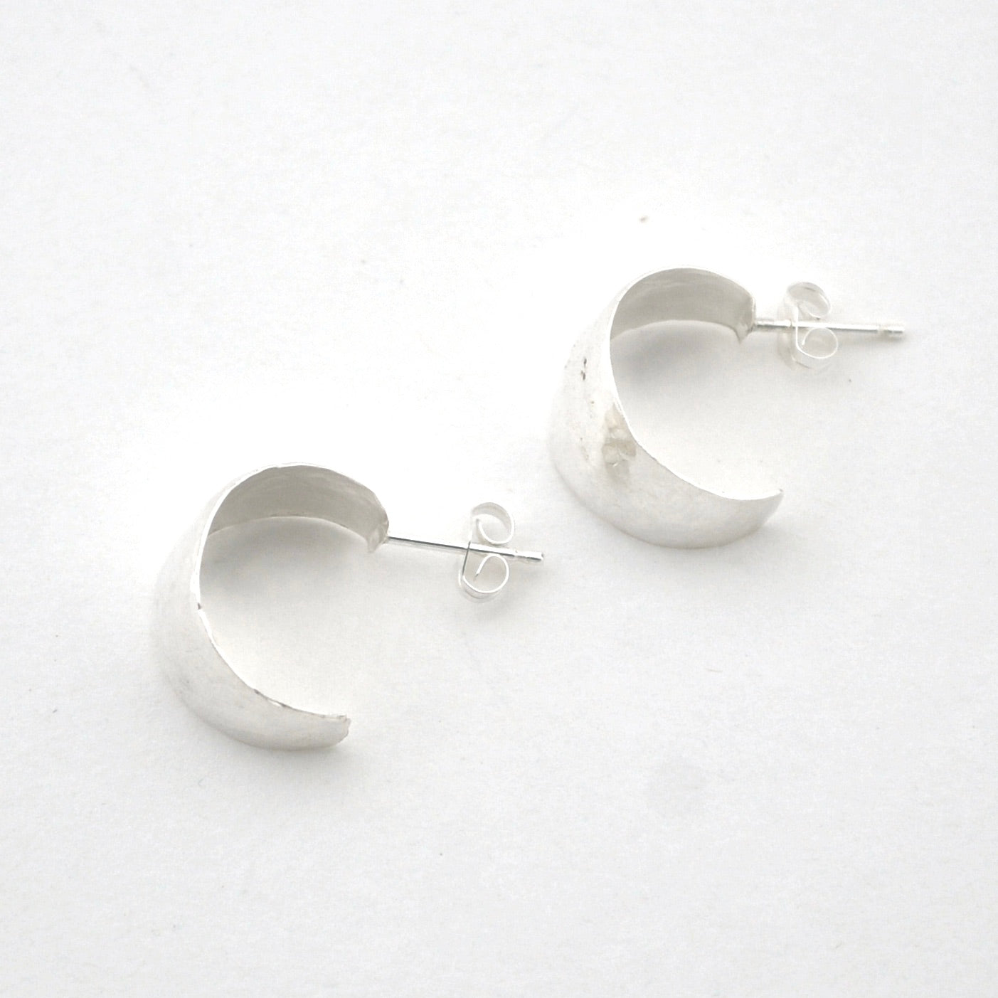 Silver hoop earrings on a white background