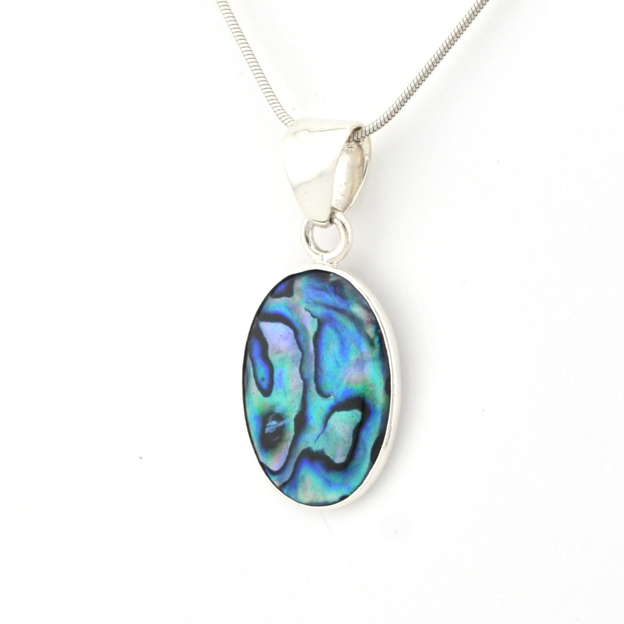 Oval abalone shell pendant on a silver chain against a white background