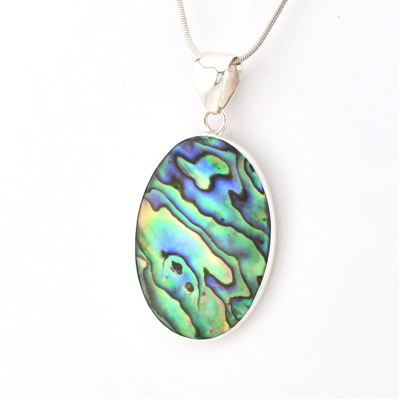 Multicolored abalone shell pendant on a white background