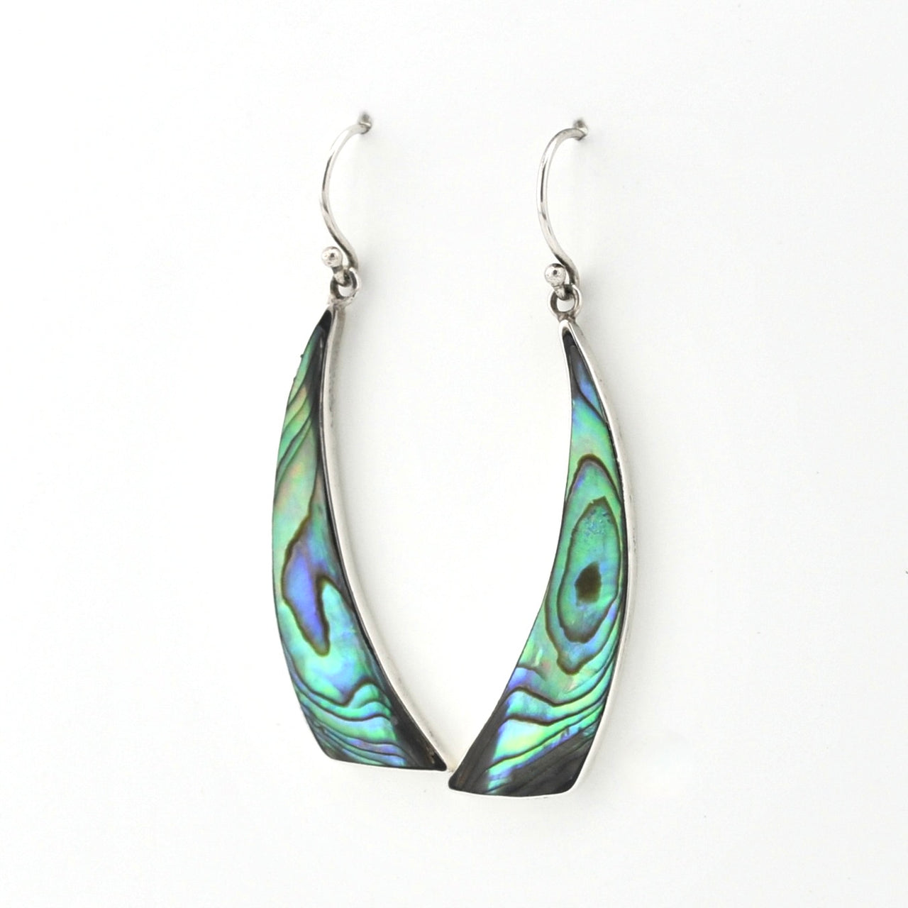 A pair of silver-toned dangle earrings with teardrop-shaped abalone shell inlays showing iridescent green, blue, and black patterns, set against a plain white background.