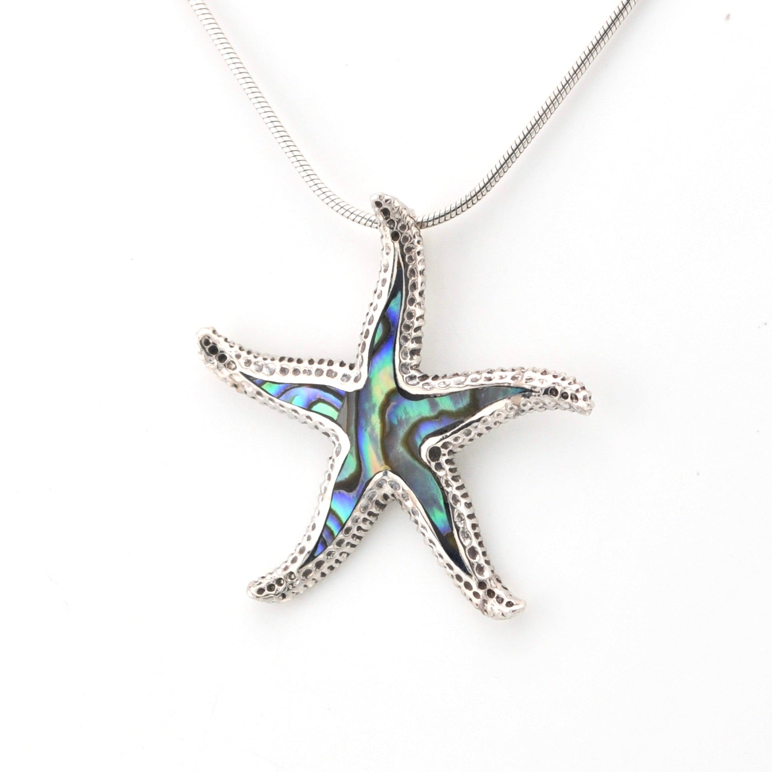 Starfish pendant necklace with abalone shell inlay on a white background