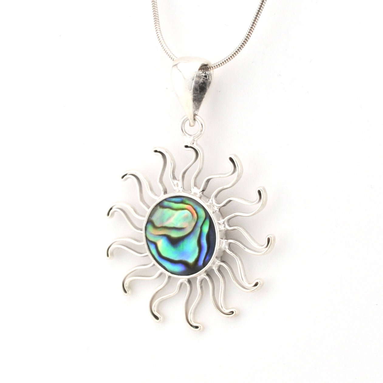 Silver sun-shaped pendant with abalone shell center on a white background