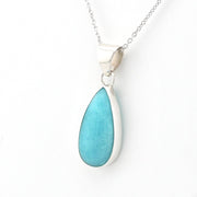 A silver teardrop pendant necklace featuring a smooth, polished light blue turquoise stone, shown on a clean white background.