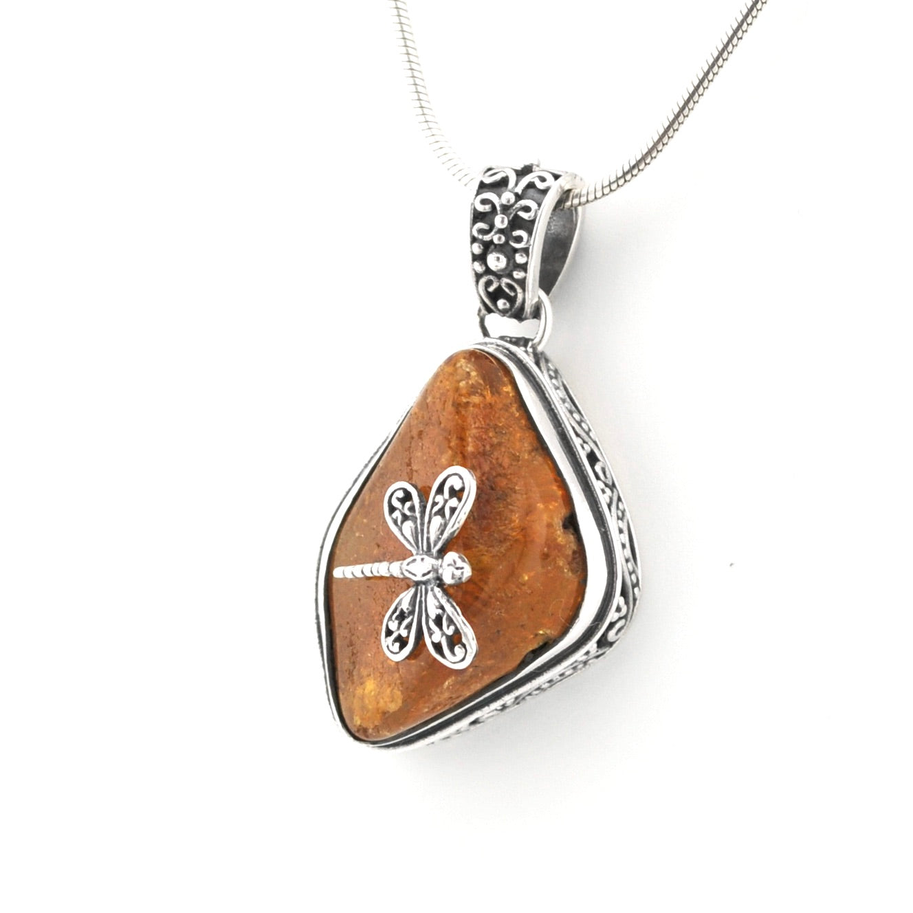 A silver dragonfly pendant necklace featuring a polished brown stone pendant with a silver dragonfly charm, suspended from a silver chain on a white background.