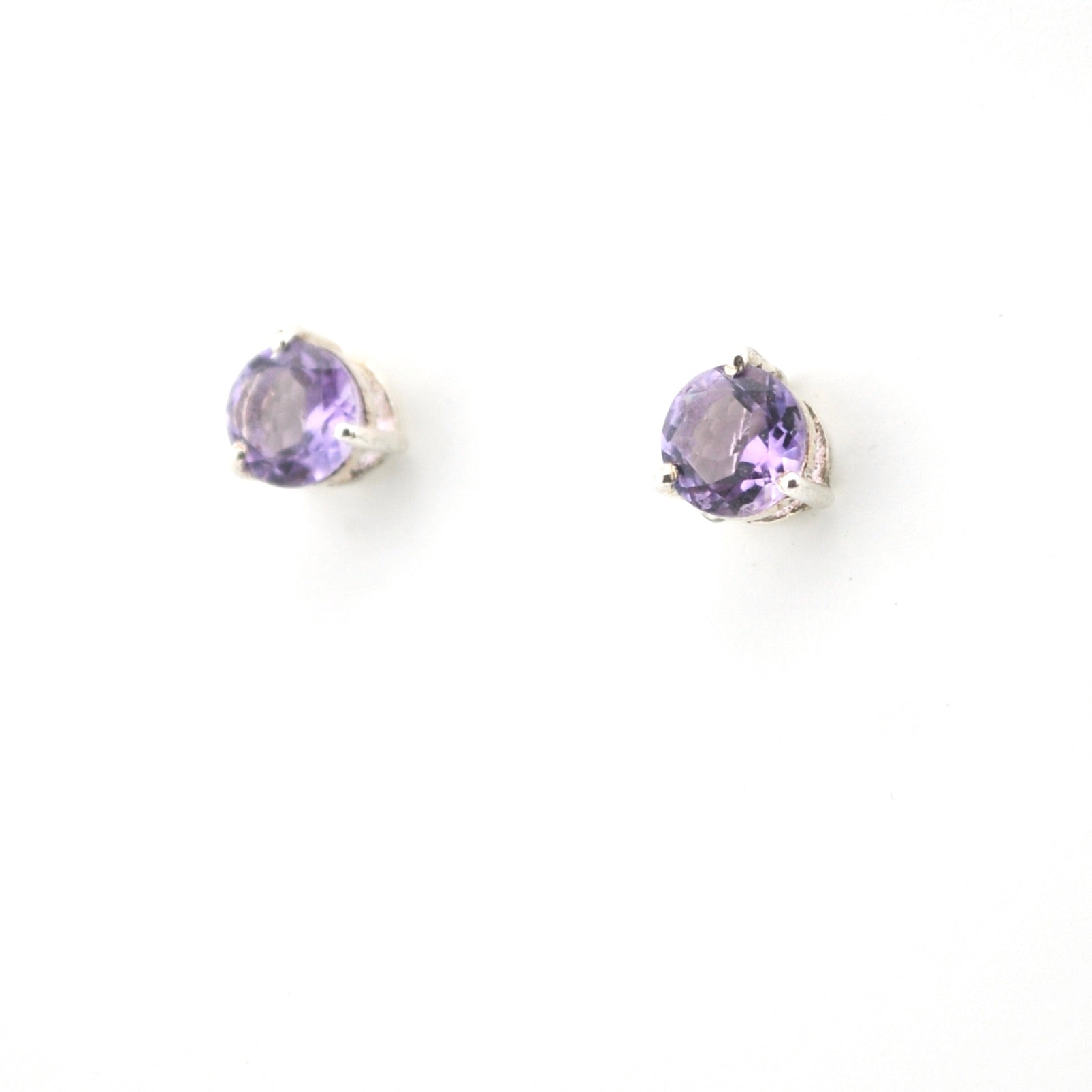 Pair of purple gemstone earrings on a white background