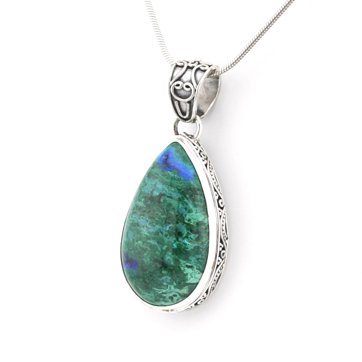 A teardrop-shaped pendant necklace featuring a green azurite gemstone with blue flashes, set in an ornate silver bezel with a matching silver chain.