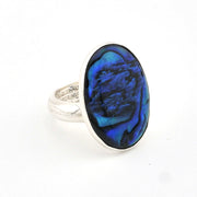 Ring with a blue oval stone on a white background