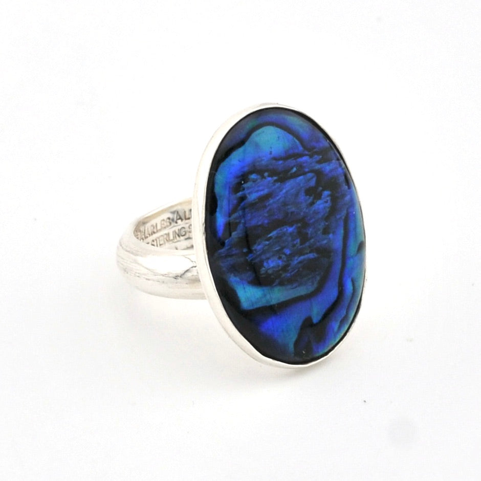 Ring with a blue oval stone on a white background