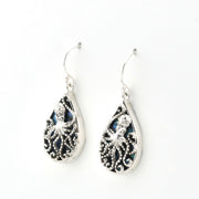 A pair of silver teardrop dangle earrings featuring intricate octopus filigree cutouts over dark iridescent inlay, shown on a plain white background.